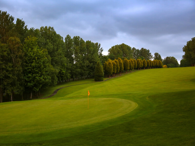 Tree lined fairway on the golf course leading down to the green at Macdonald Hill Valley Hotel, Golf And Spa