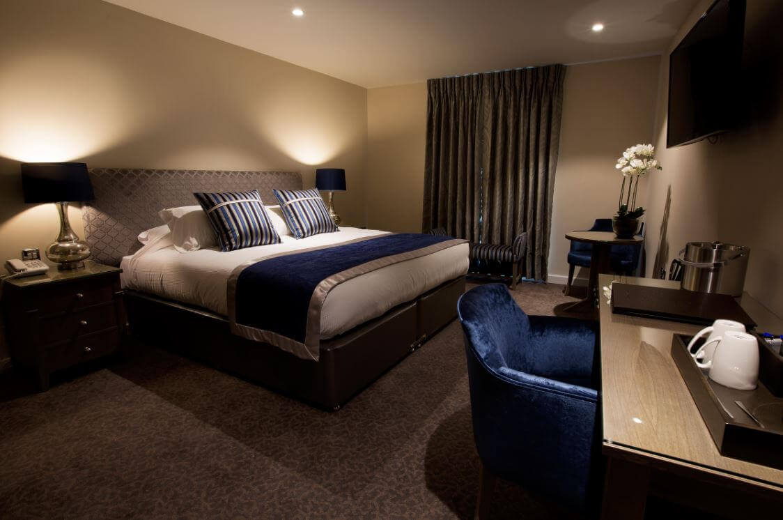 Double bedroom with luxury décor and television mounted on the wall Sandford Springs Hotel And Golf Club