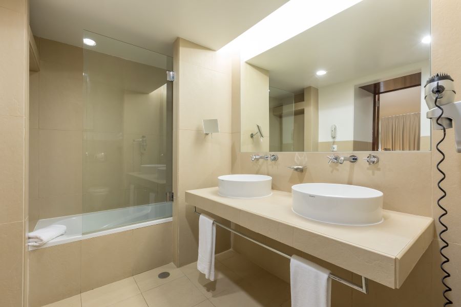 Bathroom with twin sinks at NAU Sao Rafael Suites in the Algarve