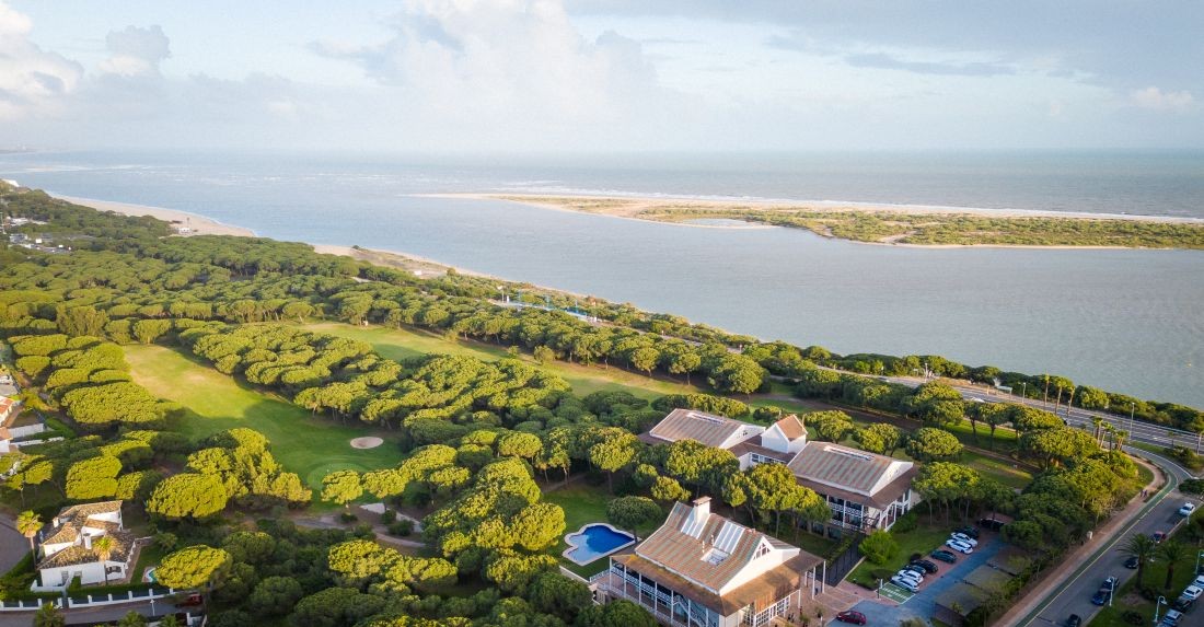 Hotel and clubhouse overlooking the golf course with the sea in the distance at Nuevo Portil Golf