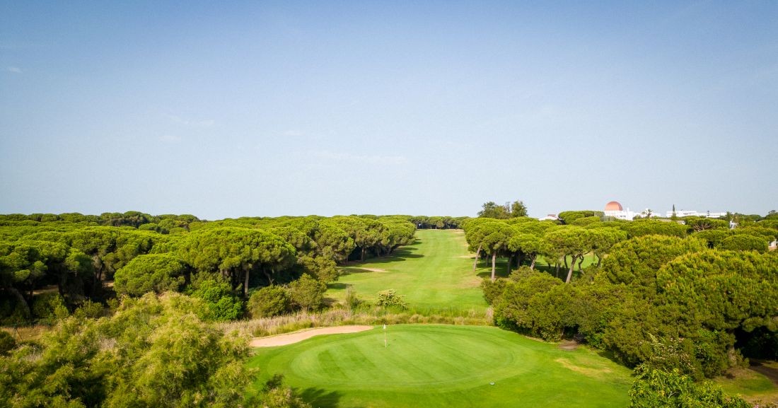 Blue sky overhead of the putting green at Nuevo Portil Golf