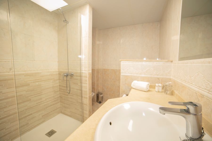 Bathroom with shower cubicle and wash basin at Hotel PYR Fuengirola