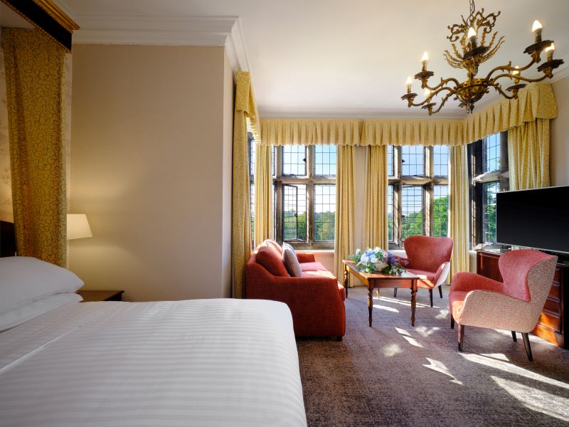 Bedroom with sofa and chairs at Delta Hotels by Marriott Breadsall Priory Country Club