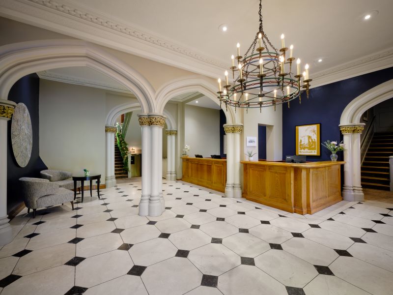 Reception with tiled floor and chandelier at Delta Hotels by Marriott Breadsall Priory Country Club