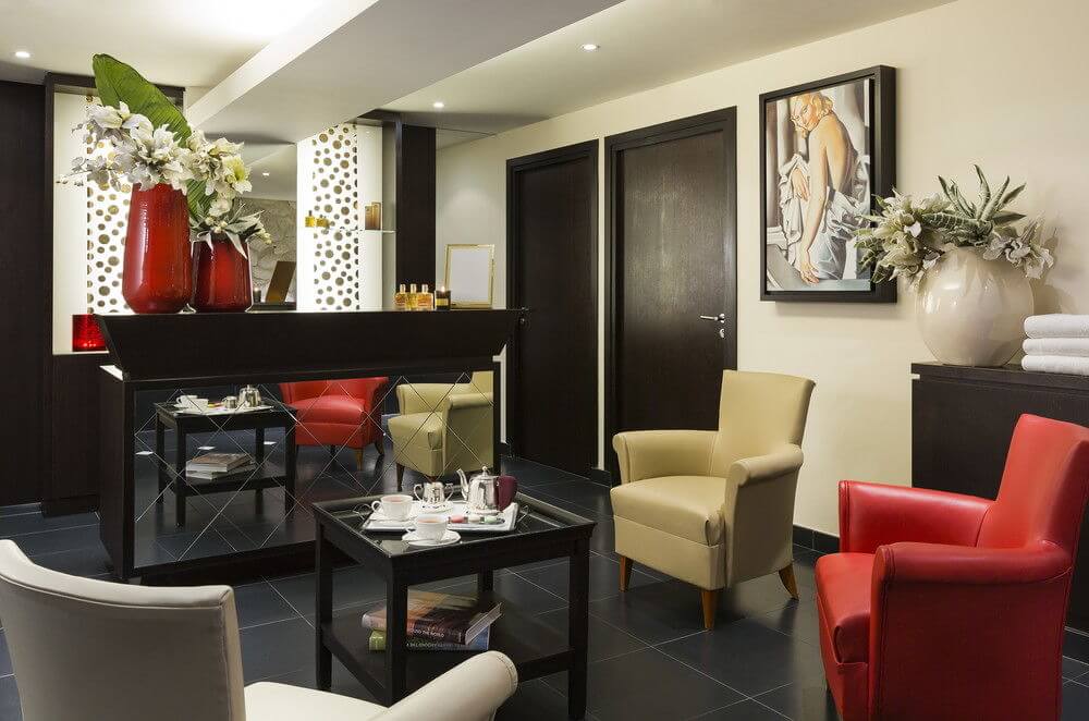 Spa reception desk at Hotel Barriere Le Westminster with leather chairs and table with coffee tray