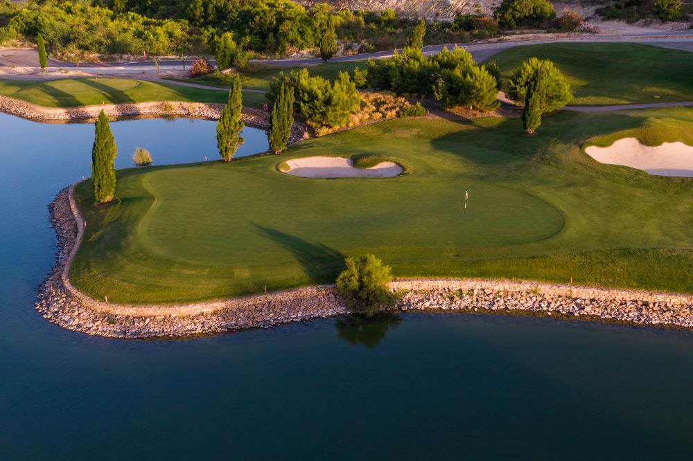 Water around the putting green at Las Colinas Golf And Country Club