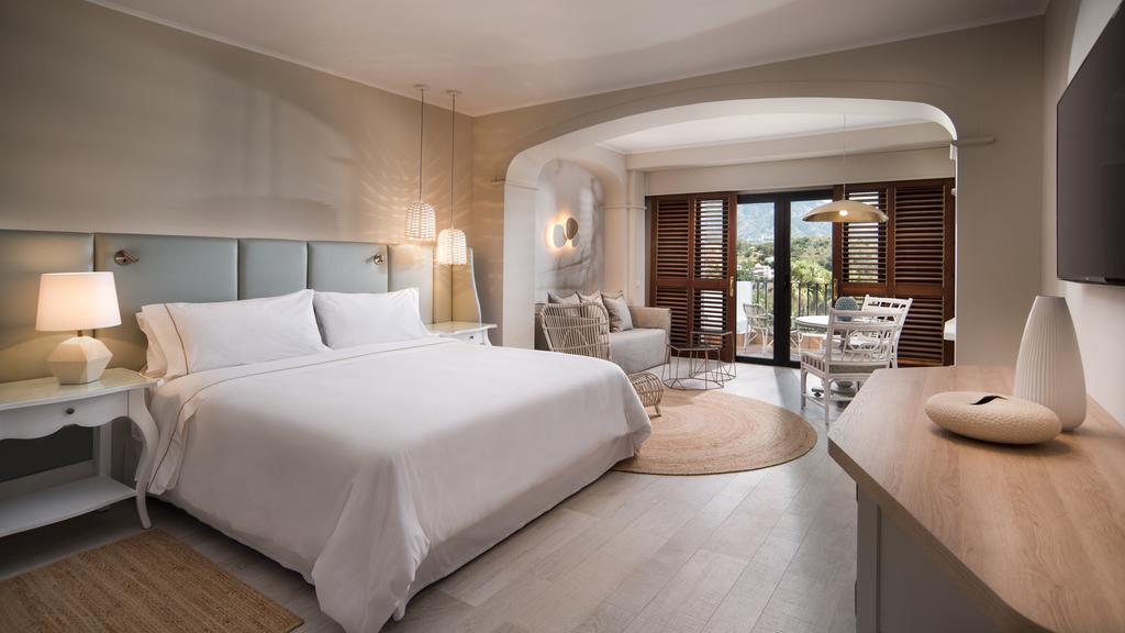 The Westin La Quinta Golf Resort & Spa bedroom with double bed, lamps, rug, sofa and balcony