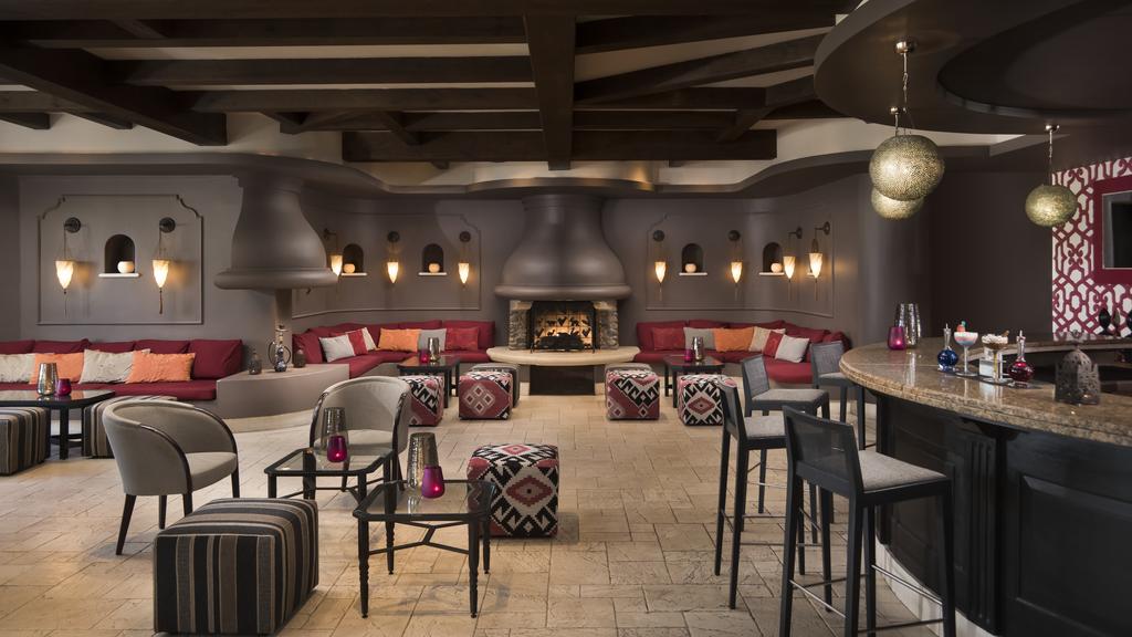 Bar at The Westin La Quinta Golf Resort & Spa with open fire, cube seats, tables and stools