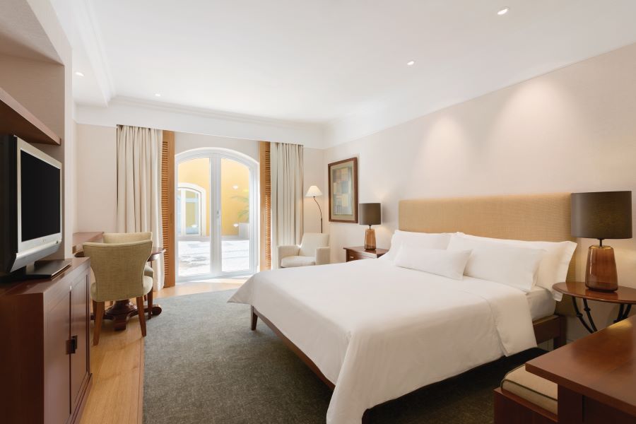 Double bed in room at Dolce by Wyndham CampoReal Lisboa