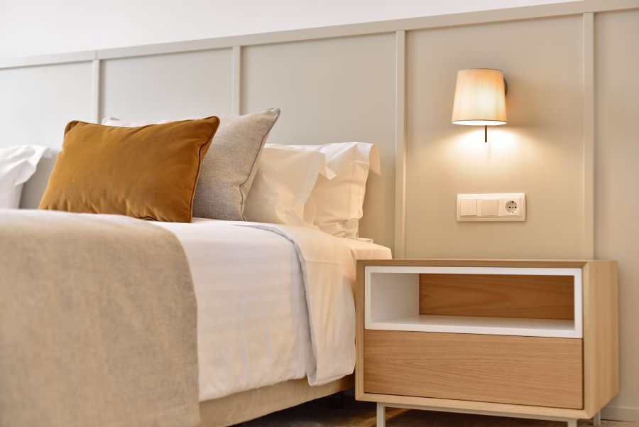 Bedside cabinet and wall mounted lamp at Dolce by Wyndham CampoReal Lisboa