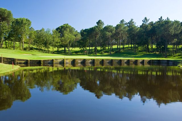 Blue lake protecting the green at Camiral Golf & Wellness