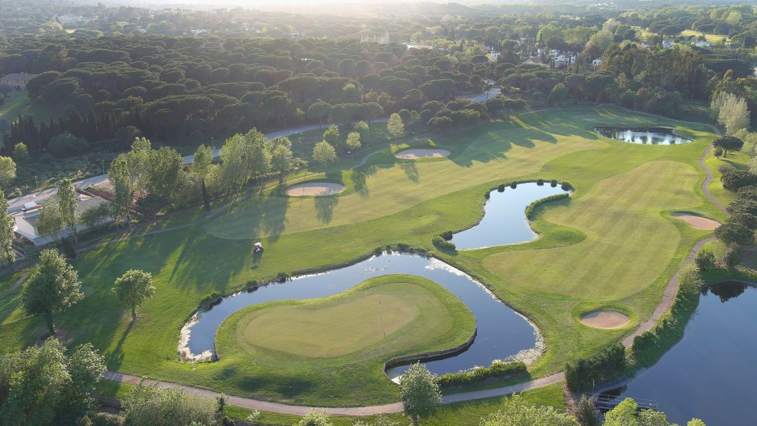 Lake guarding the putting green of one hole at Club de Golf Costa Brava