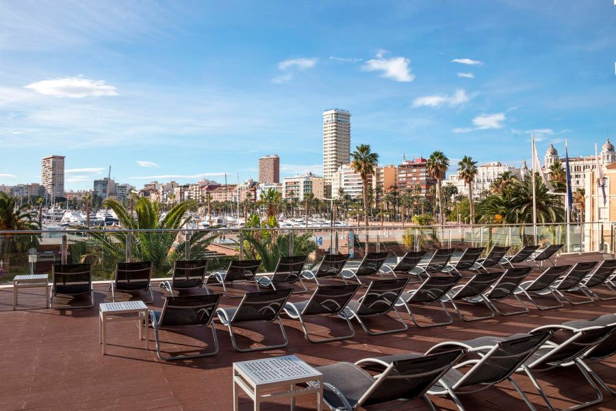 Sun loungers on wooden terrace at Melia Alicante
