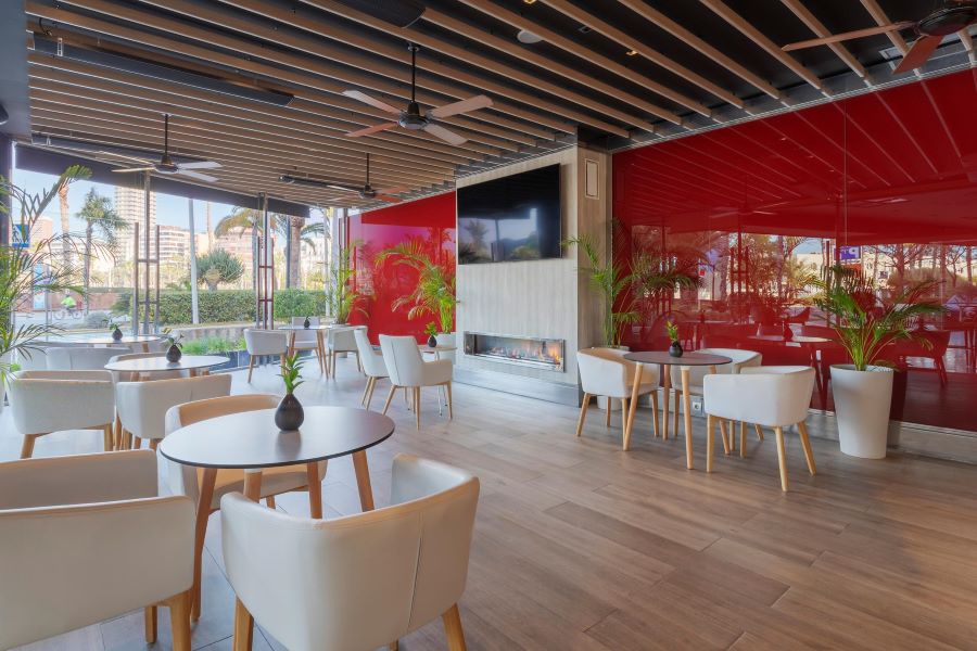 Television on the wall in one of the bars at Melia Alicante Hotel