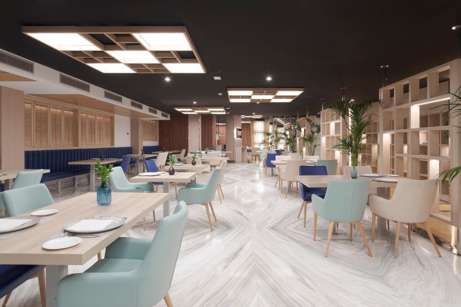 Restaurant with spearmint green chairs at Melia Alicante Hotel