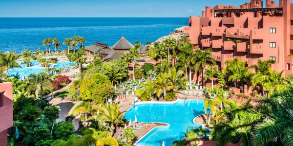 Sheraton La Caleta Resort And Spa overlooking the palm trees, swimming pools, sun loungers and parasols