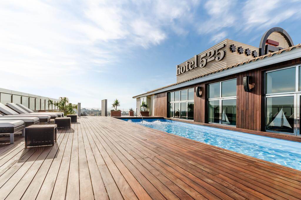 Rooftop swimming pool and sun lounge area at 525 Hotel