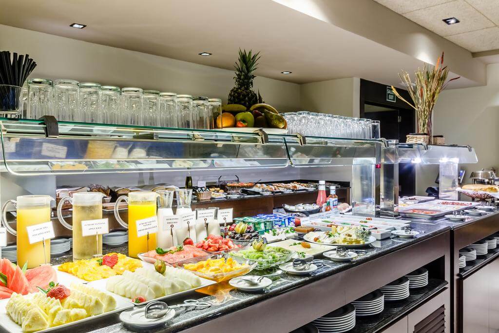 Breakfast buffet counter at 525 Hotel with fresh fruit and yoghurt
