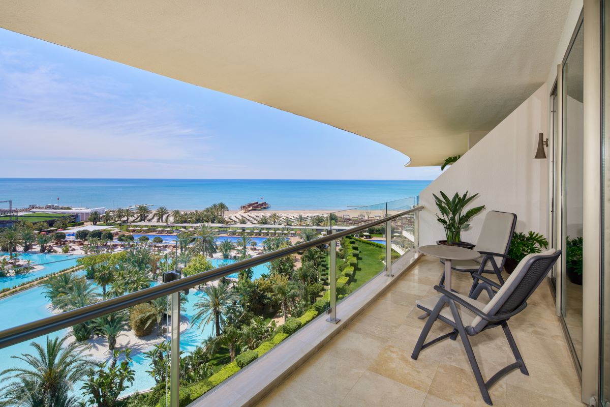 Balcony view of swimming pools and sea at Maxx Royal Golf & Spa