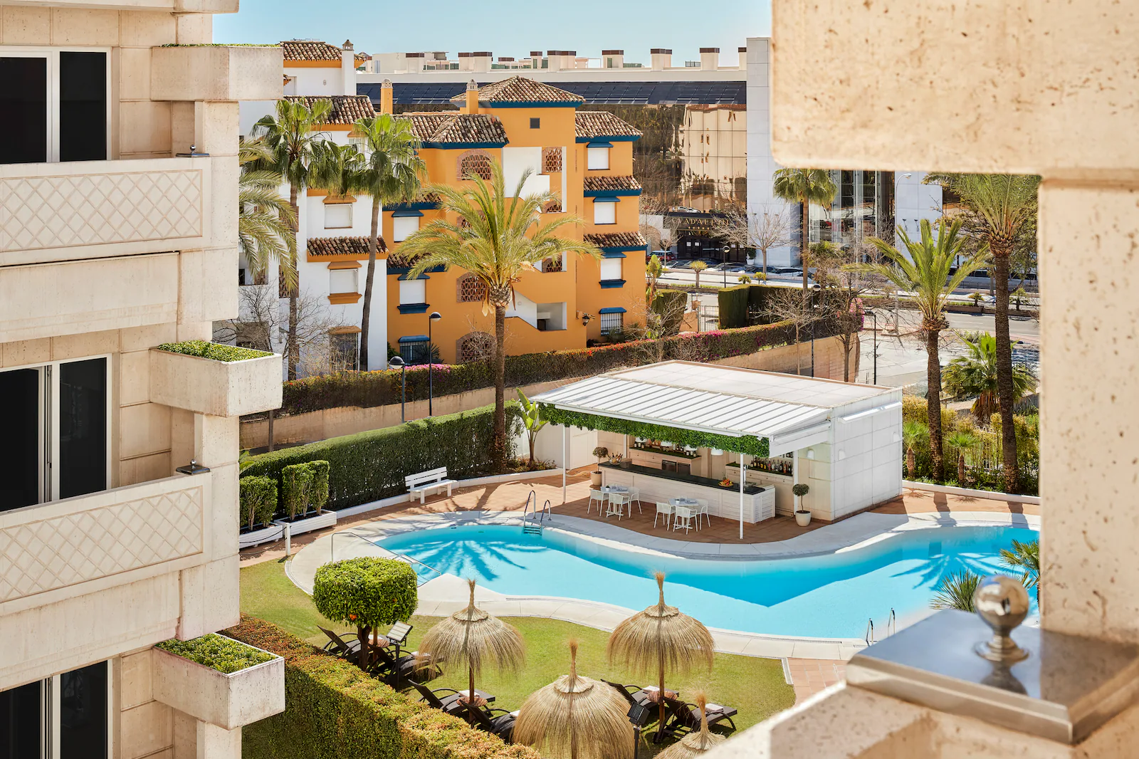 Pool bar with swimming pool in front at NH Collection Marbella