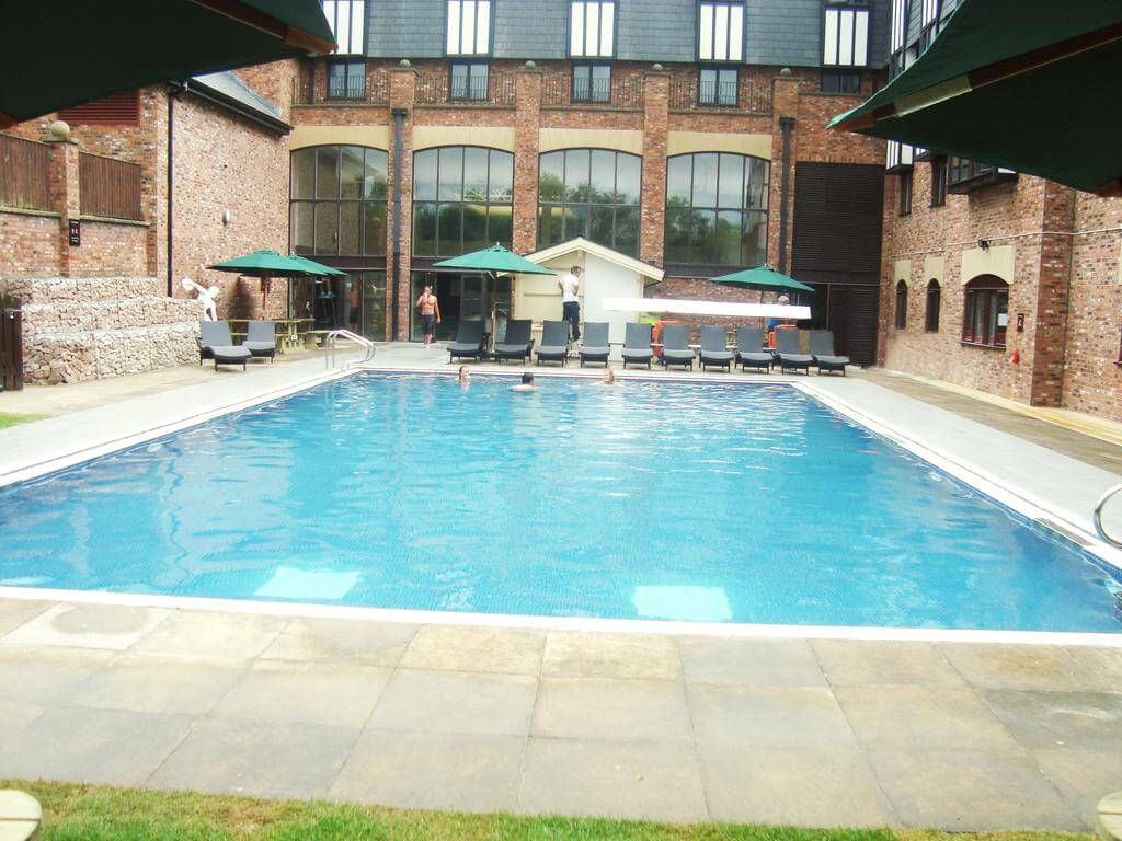 Outdoor swimming pool and loungers at Herons Reach Golf Resort