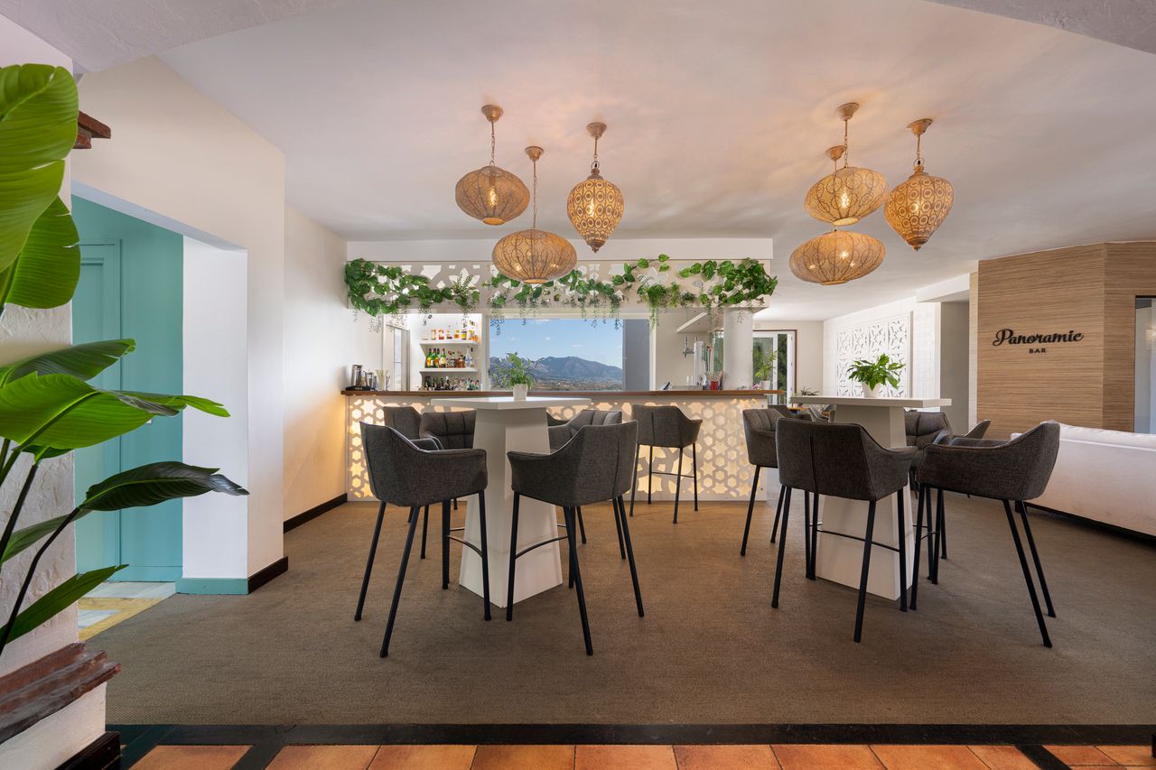 Bar with tables and stools at La Cala Golf Resort