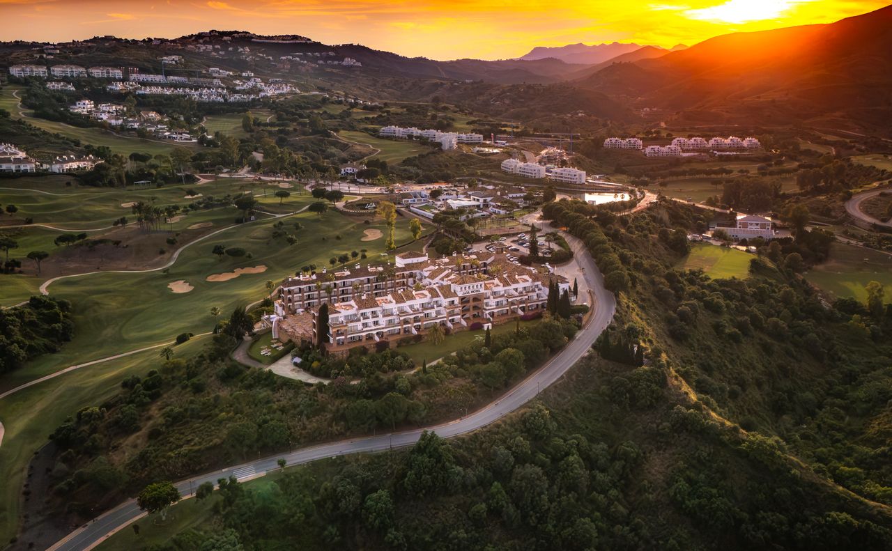 La Cala with sun setting in the distance behind Mijas Costa mountains
