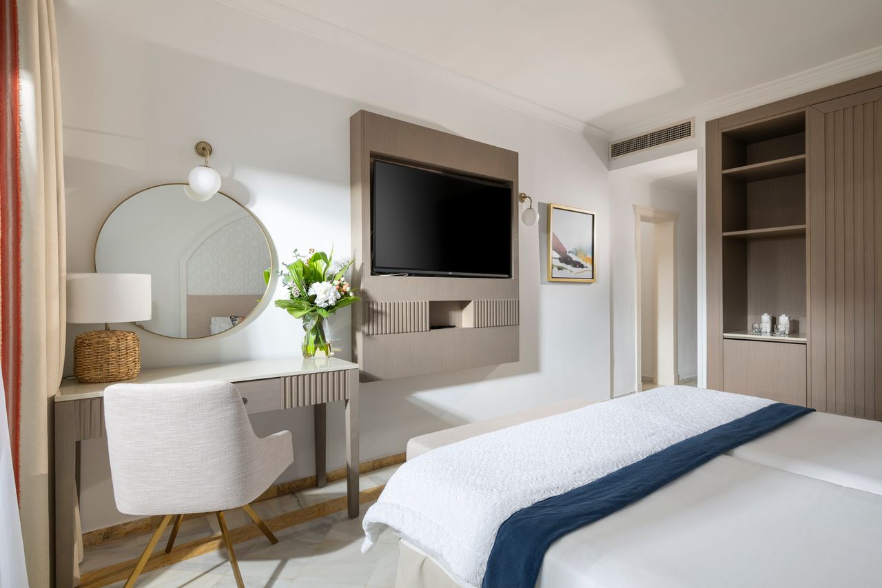 Bedroom with television on the wall at La Cala Golf Resort