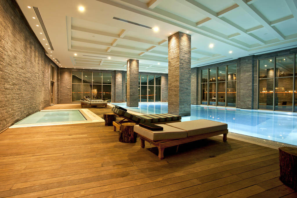 Indoor swimming pool with loungers at Kaya Palazzo Golf Resort