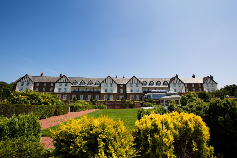 Outside view of Carden Park Hotel with resort in the distance