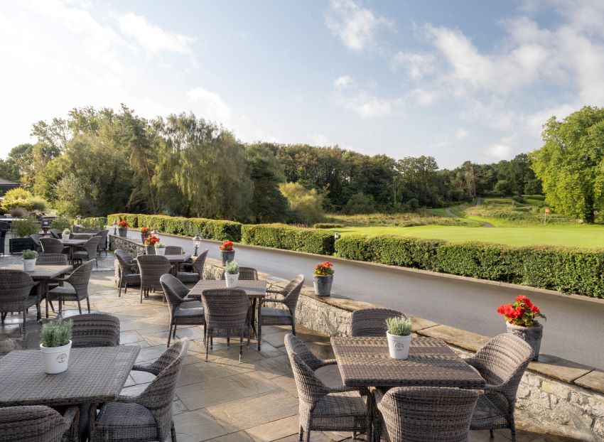 Outdoor seating area facing the golf course at Delta Hotels by Marriott St. Pierre Country Club