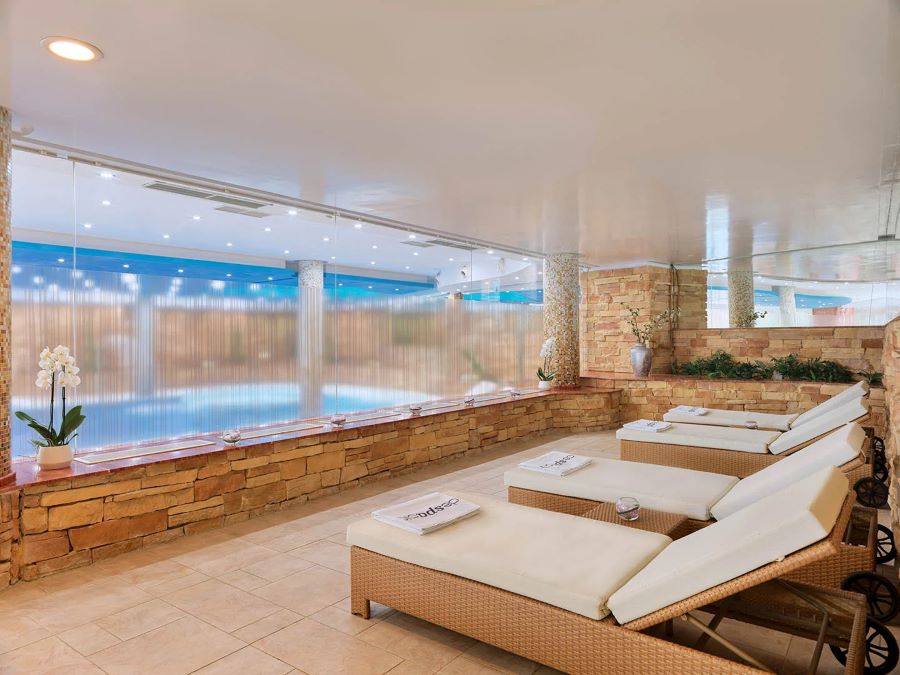 Loungers overlooking the pool in the spa at H10 Playa Meloneras Horizons Collection