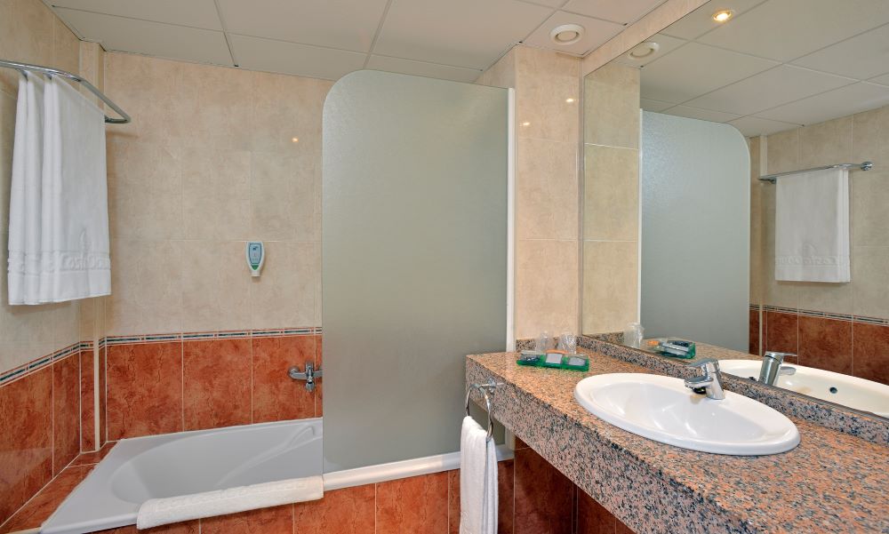 Bathroom with shower and sink in Sol Costa Daurada by Melia