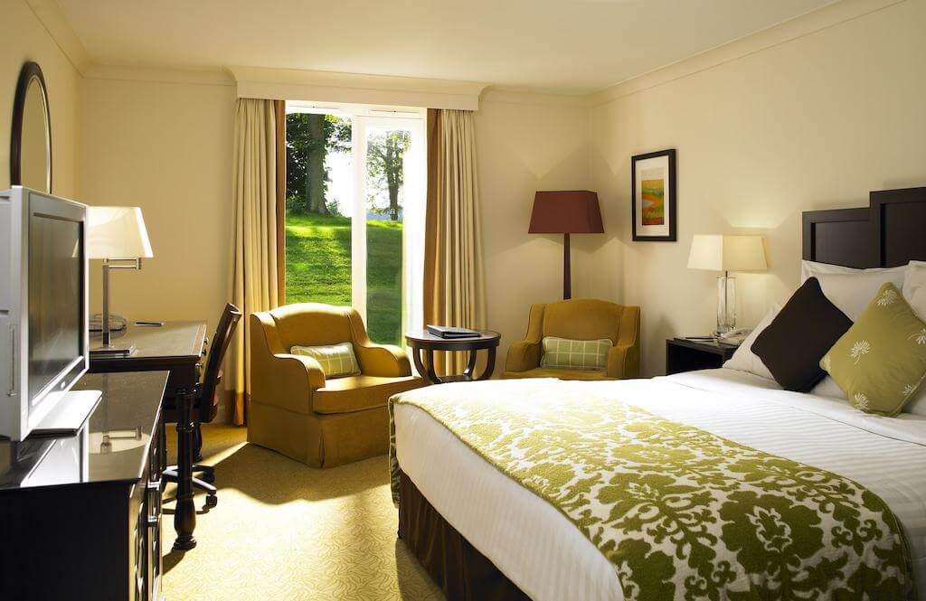 Bedroom at St Pierre Marriott Hotel and Country Club with armchairs, desk, chair and television