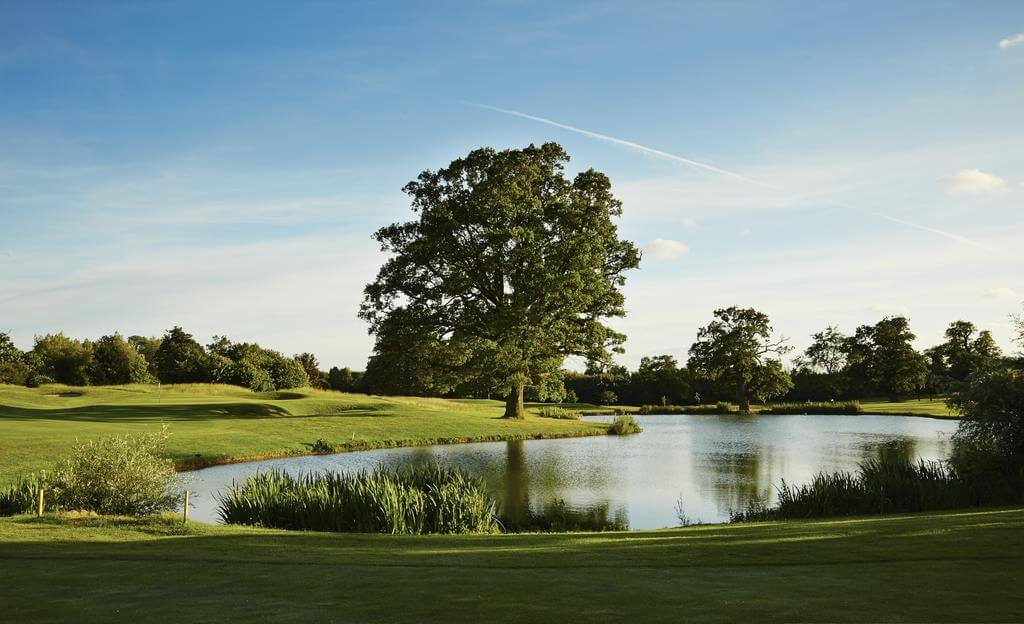 Golf course with lake in the distance at Hanbury Manor Golf Marriott Hotel And Country Club