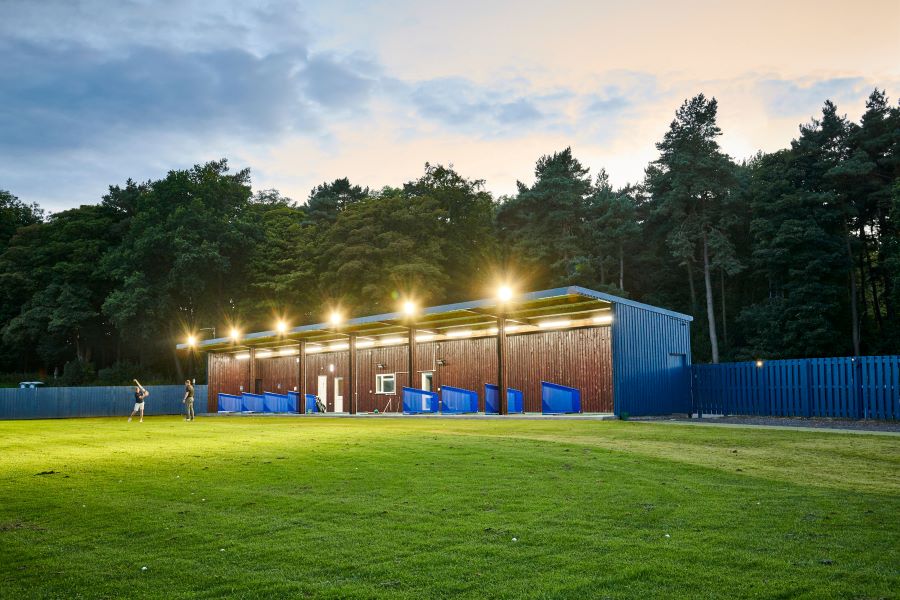 Driving range bays with floodlights on at Matfen Hall Hote Golf And Spa