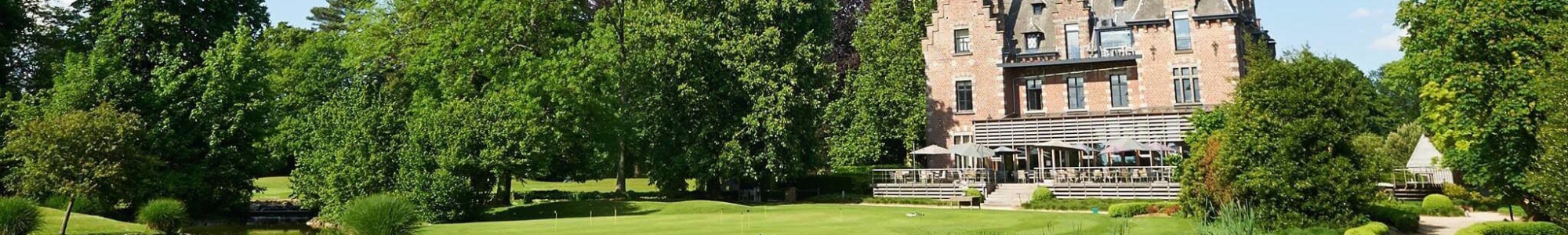 Wide shot of a golf course in Belgium overlooking water