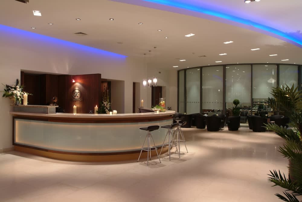 Reception area with desk and two stools at The K Club Resort