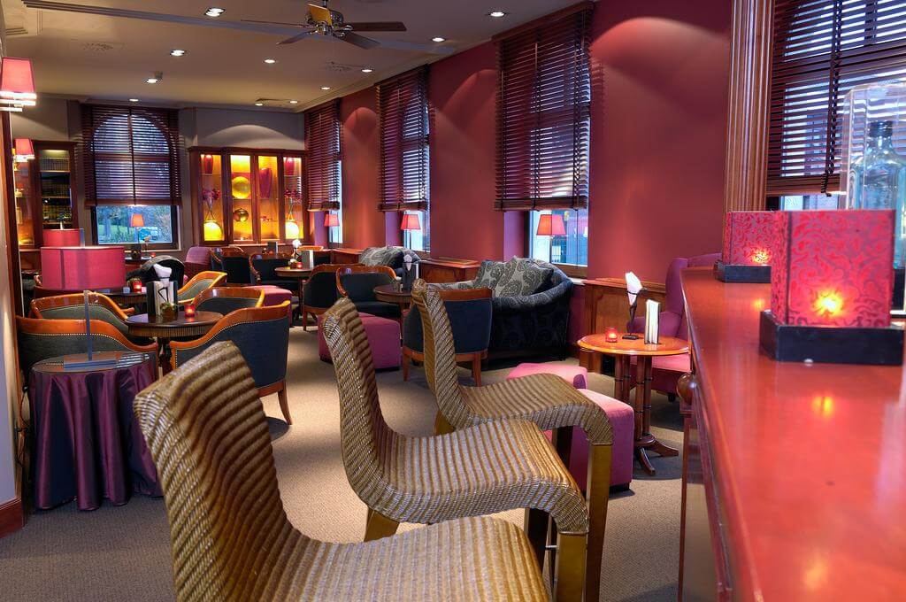 Martin's Grand Hotel bar with bar stools, purple painted walls, and blue and purple seating