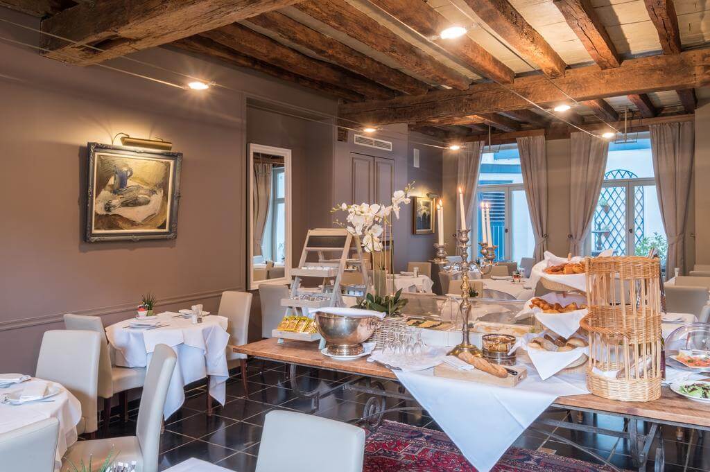 Martins Relais restaurant with breakfast buffet on wooden table including pastries