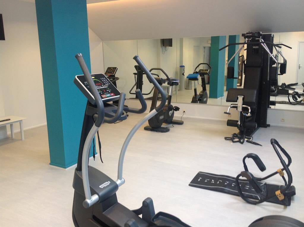 Martin's Waterloo gymnasium with floor to ceiling mirror, cross trainer, abs cradle and cycling machine