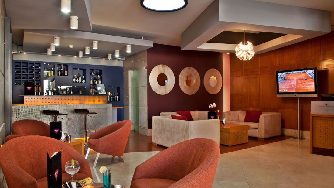 Bar area with seats and tables at American Diamonds Hotel in Lisbon city centre