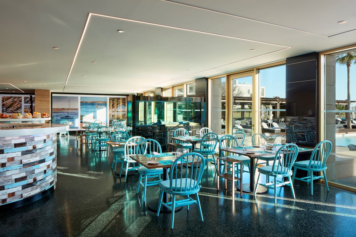Blue chairs in restaurant at Anantara Vilamoura Algarve Resort