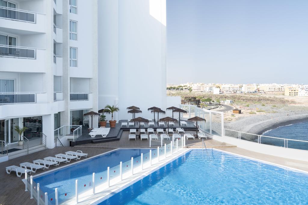 Vincci Tenerife Golf swimming pool with sun loungers overlooking the sea