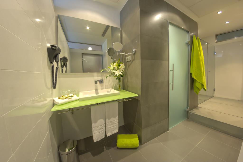 Bathroom with sink, hairdryer, toilet, and shower cubicle at Hotel La Finca Golf And Spa