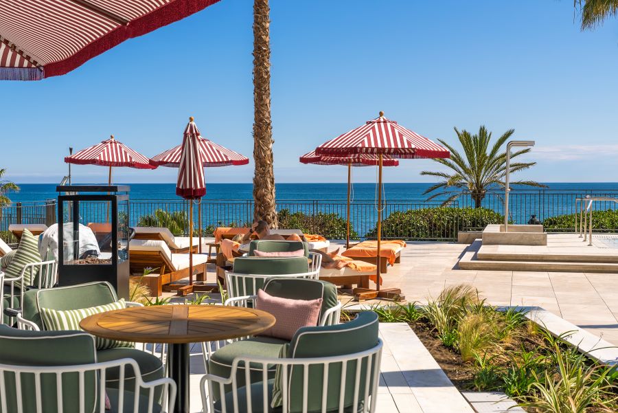Terrace with chairs, tables, and parasols at El Fuerte Marbella Hotel