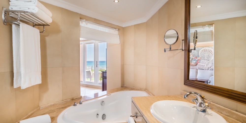Bathroom with bath tub, sink, and mirror at Guadalmina Hotel Spa And Golf Resort