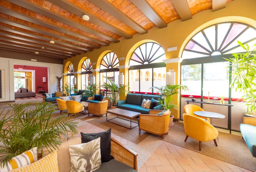 Lobby area at Hotel Isla Canela Golf Resort with yellow and green chairs