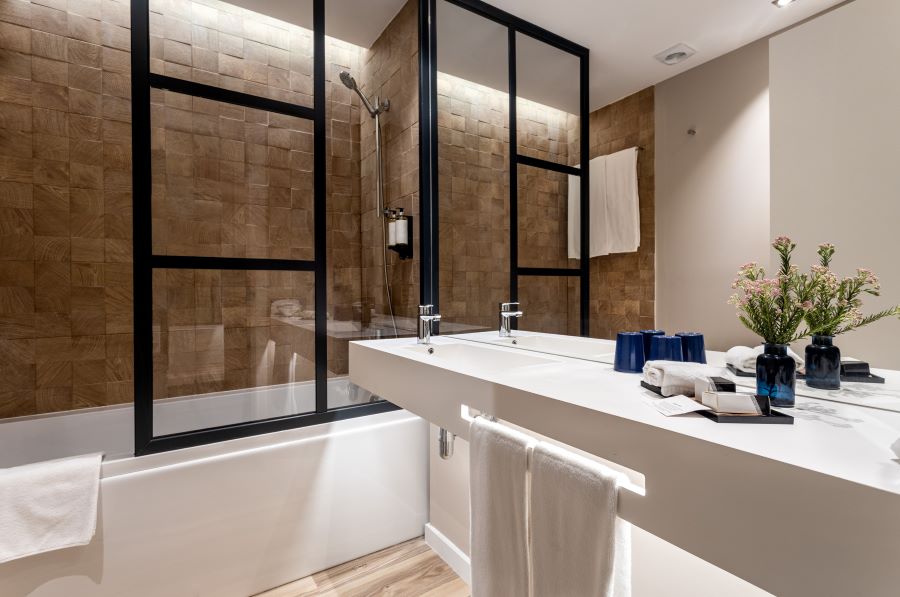 Bathroom with shower over bath, sink, and mirror at Tivoli Alvor Algarve Resort