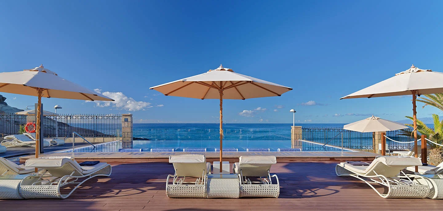 Parasol by the sun loungers on the beach at H10 Costa Adeje Palace in Tenerife